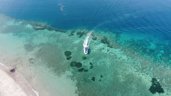 Dive boating over beautiful turquoise crystal clear ocean with stunning coral reef in Timor Leste, S