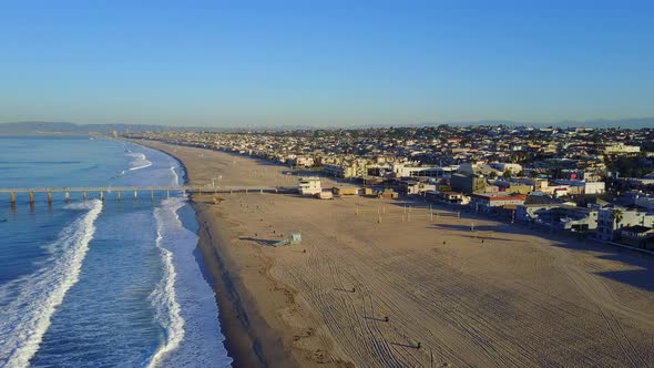 Aerial drone uav view of a pier over the beach and ocean.