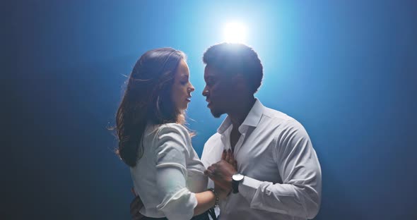 Professional Dancers Dance Dressed in White Darkskinned Man Moves Away From Woman and Spins Her