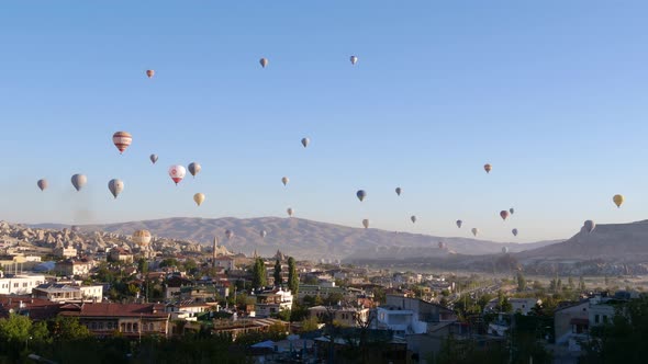 Colorful Hot Air Balloons flying over Goreme town in Cappadocia, Turkey