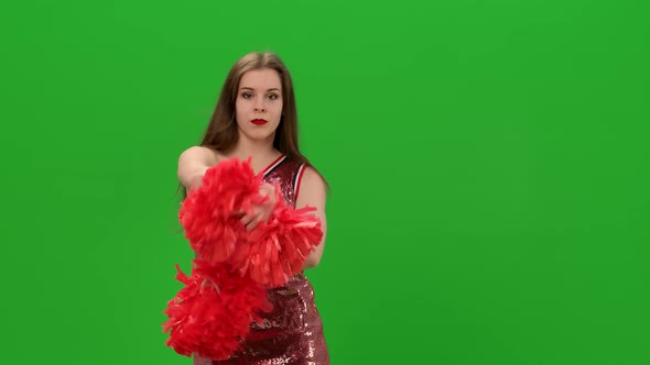 Longhaired Cheerleader Performs Poppong Elements While Training in the Studio on a Green Screen