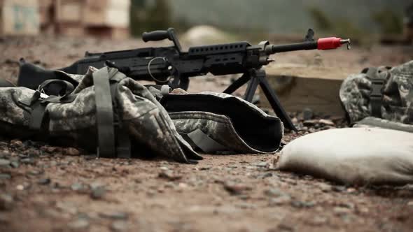 Ground level tracking shot of M240 machine guns. alt