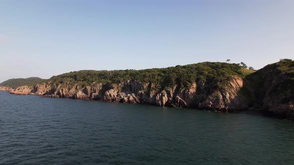 Aerial view of Kullaberg Sweden, panning left, cliff coast