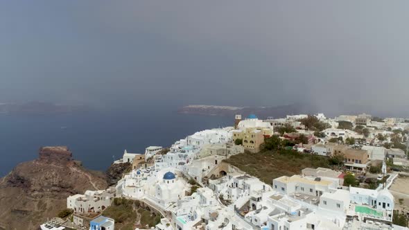 Aerial view above traditional white houses on Santorini island, Greece.