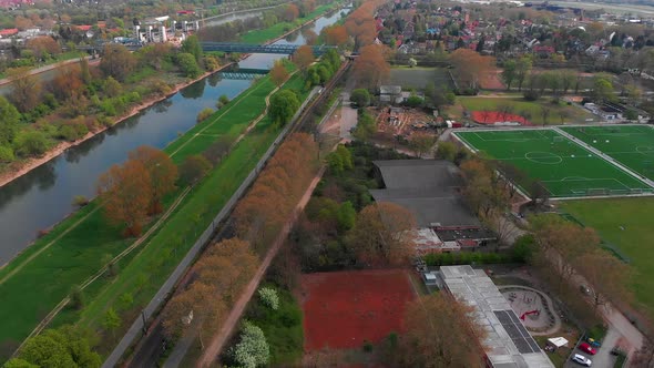 Top view of the embankment of the Neckar River. Bridges, green grass and trees.