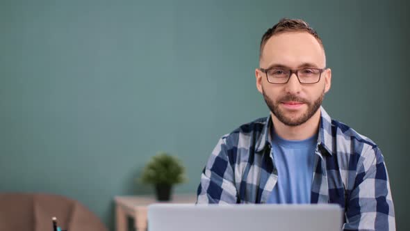 Freelancer Man Sitting in Front of Laptop at Home Office