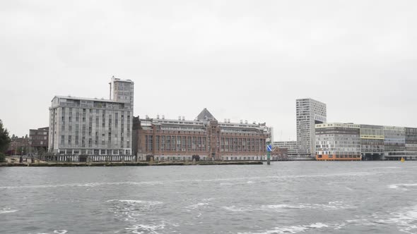 A wide shot of architectual highlights in Amsterdam such as Het Stenen Hoofd and MVDR apartments at