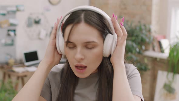 Close Up of Woman in Headphones Enjoying Music