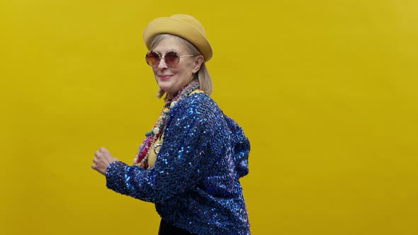 Stylish Elderly Woman On Yellow Background