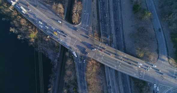 Top View Zooming Out of a Highway Junction and Train Tracks by River