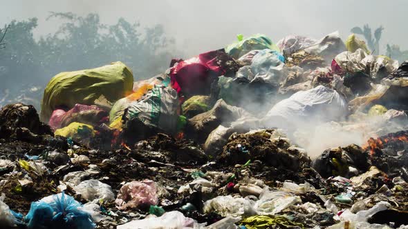 Air pollution by illegal burning pile of plastic trash landfill in Vietnam,