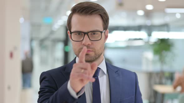 Portrait of Serious Businessman Pointing at the Camera