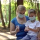 Mom Treats Her Son's Hands with Antiseptic - VideoHive Item for Sale