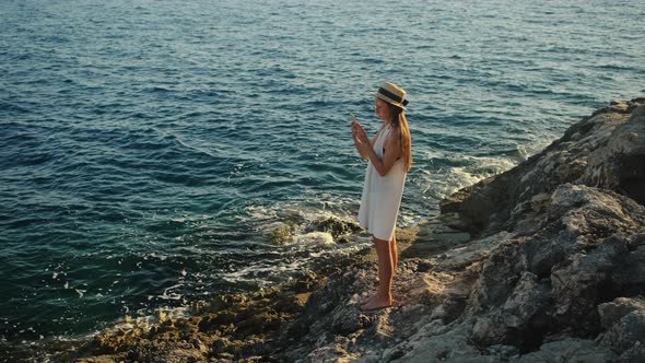 She Loves Looking at Sea and Taking Pictures