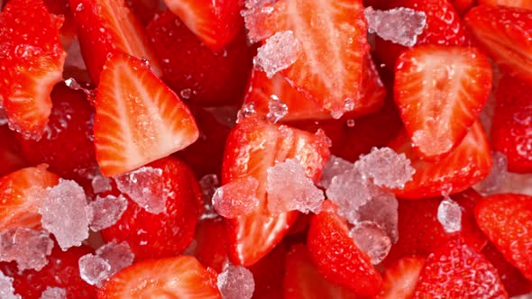 Super Slow Motion Shot of Fresh Strawberries and Crushed Ice Flying Towards Camera at 1000Fps