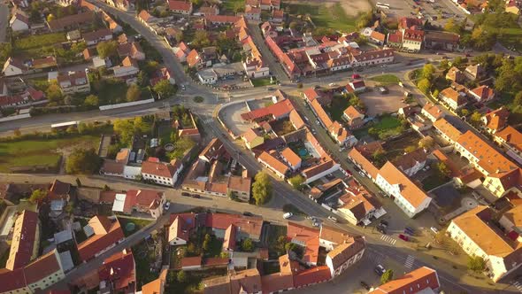 Aerial view of small old european town with red tiled roofs of small houses and narrow streets.