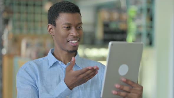 Video Call on Tablet By African Businessman 