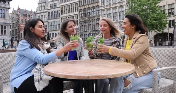 Attractive Young Women of Mixed Race Partying Outside in the City Drinking Cocktails and Smiling and