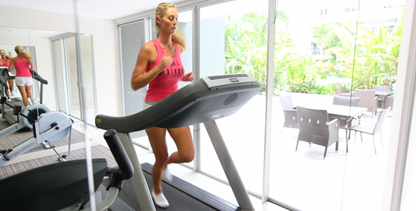 Girl in Gym Running on Treadmill