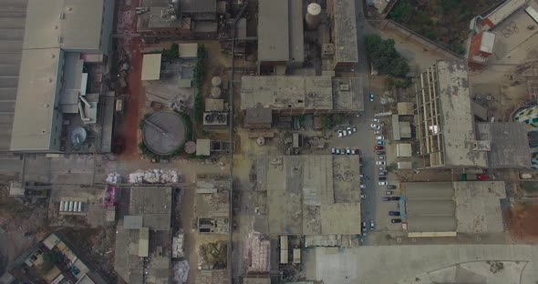 Top shot of a refinery and a factory, Bombay, India, showing roofs of the factory, cars parked at ou