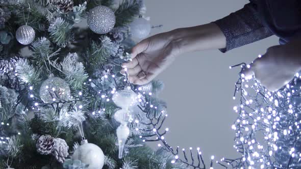Decorating Christmas Tree with Lights.