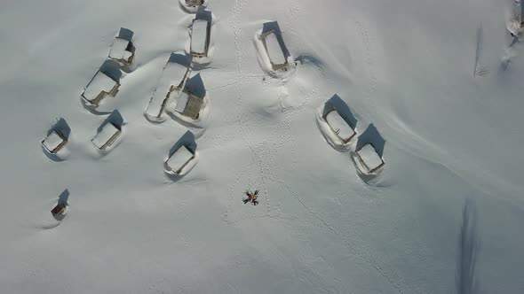 Four Travelers Lie on a Snowcovered Meadow of the Ukrainian Carpathians