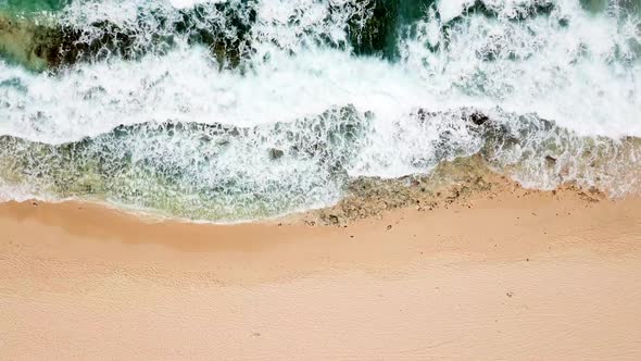 Top view vertical position of big waves going on the rocks at the beach - coast landscape