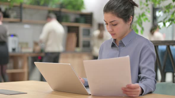 Indian Woman with Laptop Reading Documents