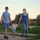 A Family with a Child in Medical Masks Walk Near the Lake - VideoHive Item for Sale