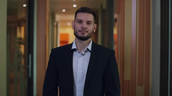 Confident Successful Young Caucasian Businessman Posing in Office Corridor