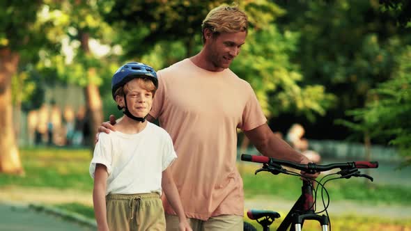 A smiling father is walking with his son