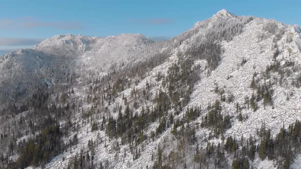 Drone Flight Through Dramatic, Snowy Winter Mountain Range