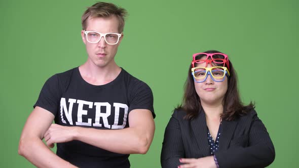 Mature Asian Businesswoman and Young Scandinavian Nerd Man Together