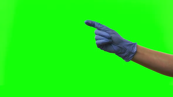 Doctors Female Hand in Blue Glove Is Making Symbolic Gestures Pointing Something. Green Screen