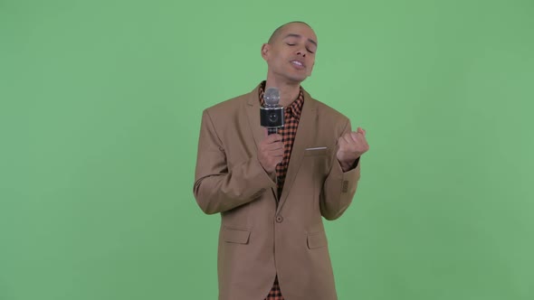 Sad Bald Multi Ethnic Businessman Singing with Microphone