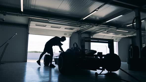 Racing Car is Getting Checked By a Specialist with a Laptop