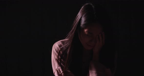 Woman crying in the dark