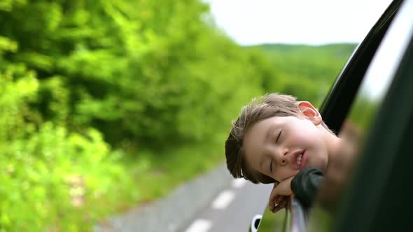 Dreaming Boy Looking Out From the Car Window