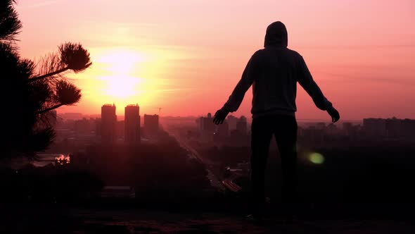 Silhouette Male at Sunrise Rising Hands Urban City View