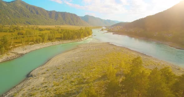 Low Altitude Flight Over Fresh Fast Mountain River with Rocks at Sunny Summer Morning