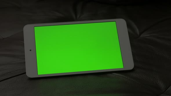 Exposed on couch modern tablet with green screen display 4K 2160p 30fps UltraHD footage - Blank chro