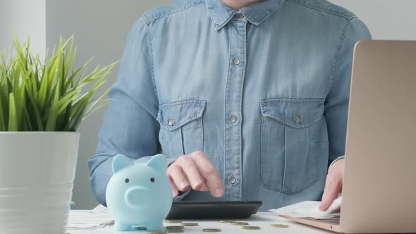 Woman Calculating Finance Money Using Calculator Laptop Computer at Home Workplace Table