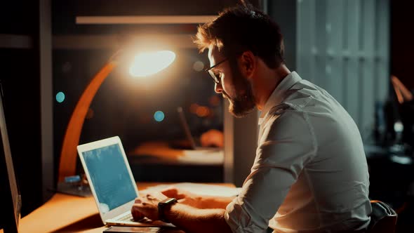 Tired Worker Overworked On Computer. Frustrated Businessman Working Alone. Office Work Overtime.