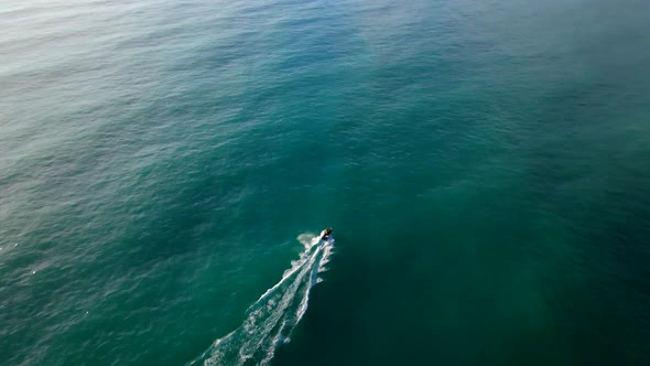 Fast motorboat speeding across the green blue sea near New Zealand