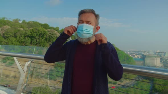 Elderly Vaccinated Man Putting Off Mask and Enjoying Fresh Air