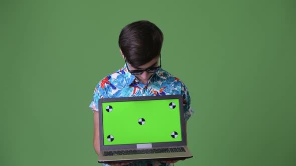 Young Handsome Iranian Teenage Boy Ready for Vacation Against Green Background