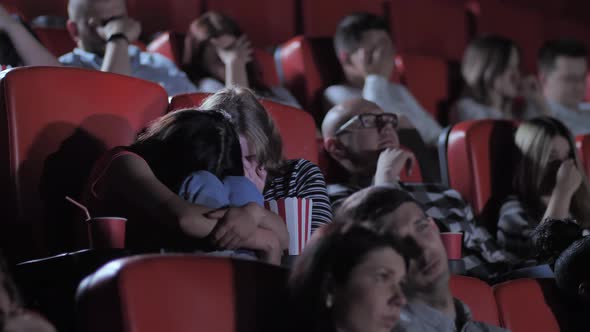 Two Schoolgirls Watching Exciting Horror in Cinema