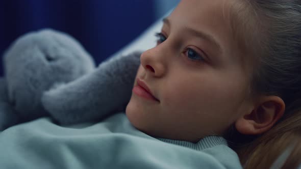 Portrait Girl Lying in Bed with Plush Toy on Hospital Checkup in Pediatric Unit