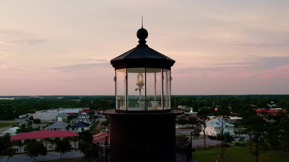 Aerial close up going around the top of a lighthouse at sunset in Port St. Joe Florida