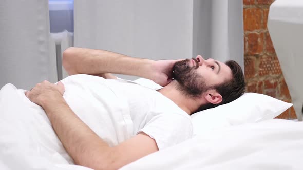 Beard Man in Lying in Bed Thinking and Imagining at Night